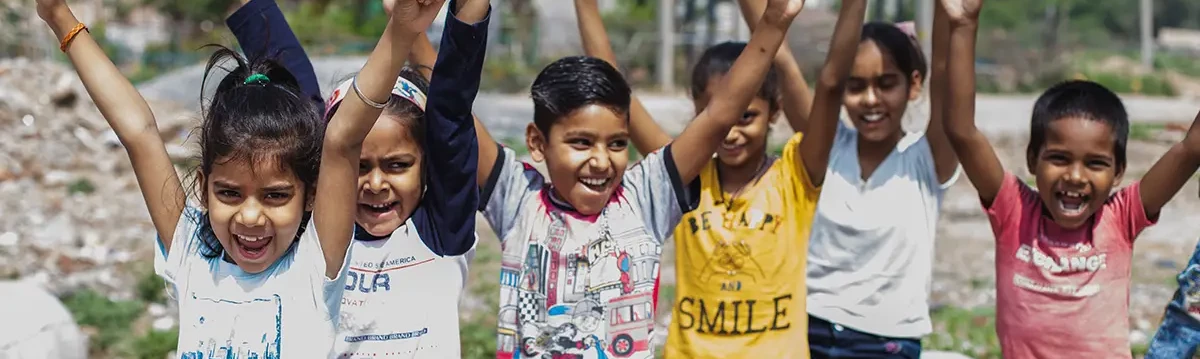 An image containing children who are smiling after getting education with the help of non profit organizations.