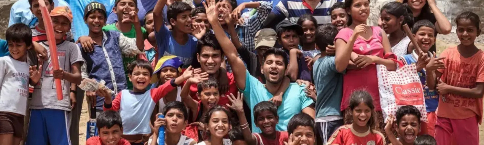 Children and volunteers participating in a community event promoting child rights, education, and inclusion.