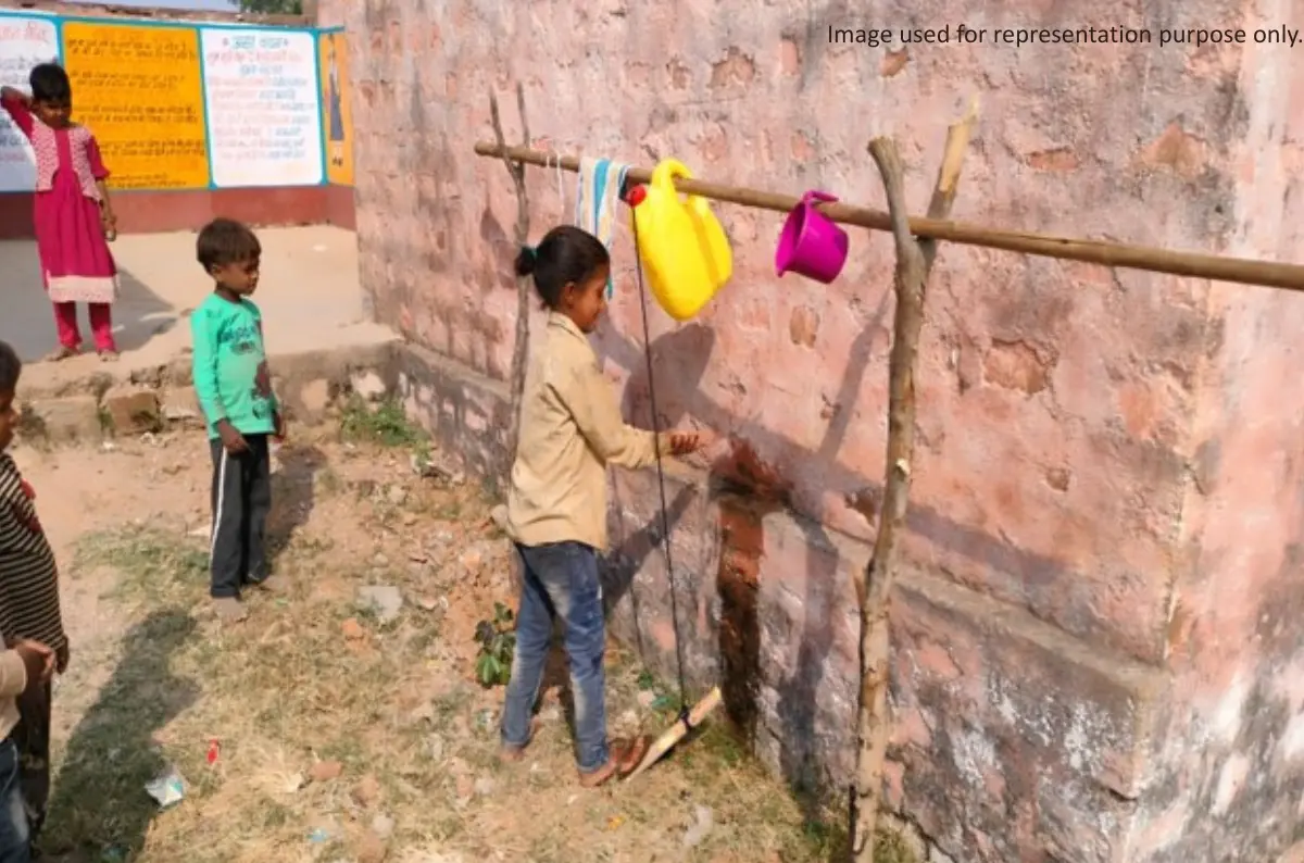 Children washing their hands at a handwashing station to promote hygiene